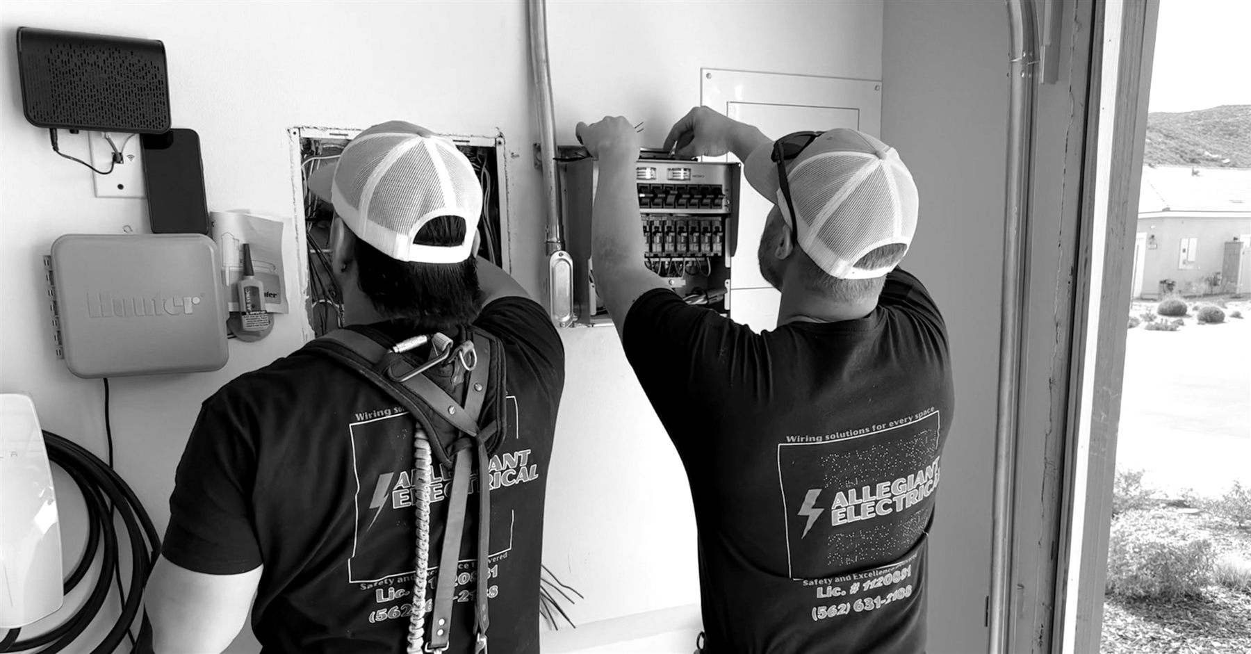 Allegiant Electrical working on wiring at an open panel